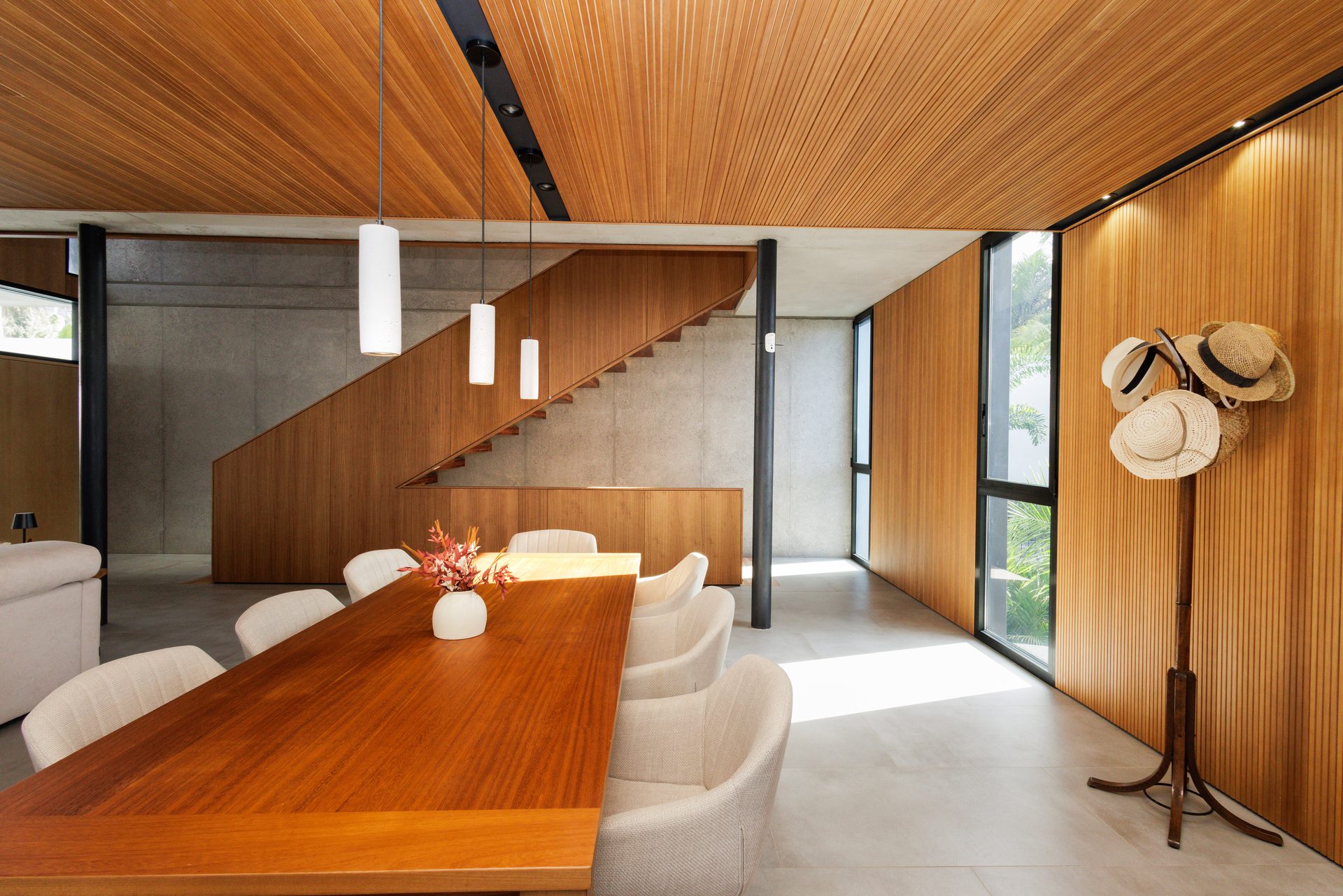 Comedor de Villa Bali con mesa de madera bajo techo de madera, abierto al salón